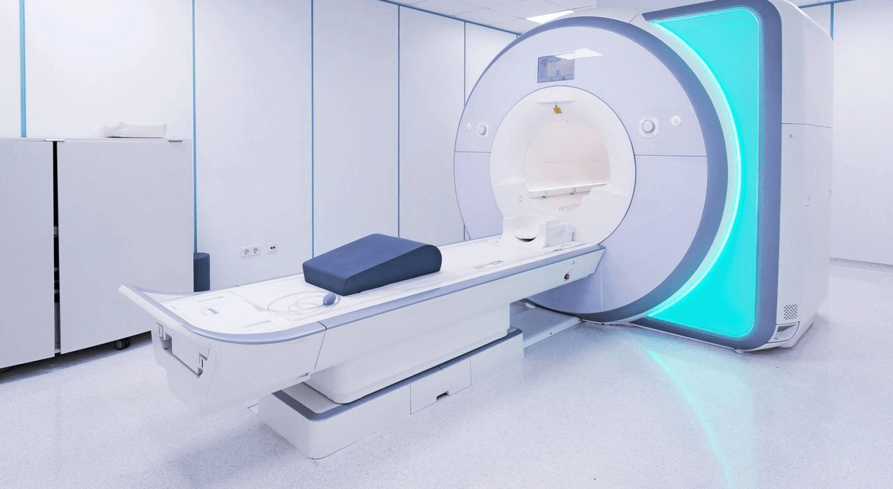 A room with a large mri machine and a table.