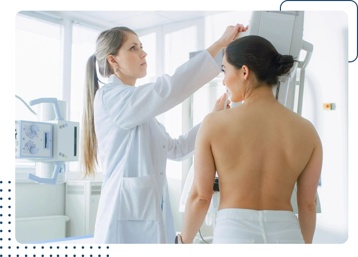 A woman is getting her breast checked by an oncologist.